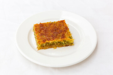 traditional dessert kadayif with pistachio on white background