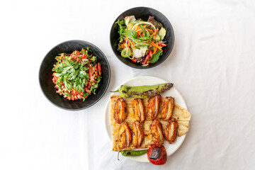 Chicken wings, chicken kebab with grilled vegetables