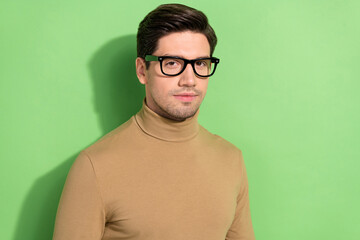 Photo of half turned young person calm face look camera isolated on green color background