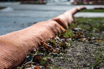 selective focus on filter sock around exposed dirt at a construction site to prevent stormwater...