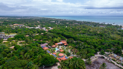 Aerial view of Imbassai beach, Bahia, Brazil. Beautiful beach in the northeast with a river and palm trees.