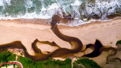 Aerial view of Imbassai beach, Bahia, Brazil. Beautiful beach in the northeast with a river and...