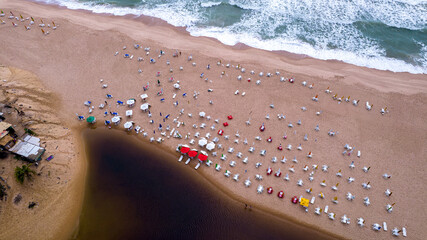 Aerial view of Imbassai beach, Bahia, Brazil. Beautiful beach in the northeast with a river and palm trees.