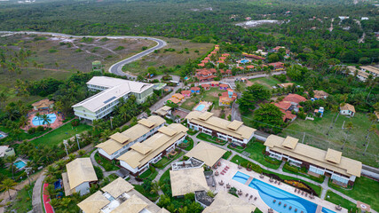 Aerial view of Imbassai beach, Bahia, Brazil. Beautiful beach in the northeast with a river and palm trees.