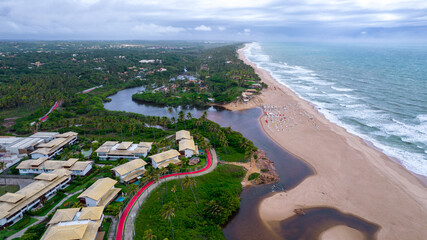 Aerial view of Imbassai beach, Bahia, Brazil. Beautiful beach in the northeast with a river and palm trees.