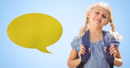 Digital composite of smiling schoolgirl with backpack by blank speech bubble