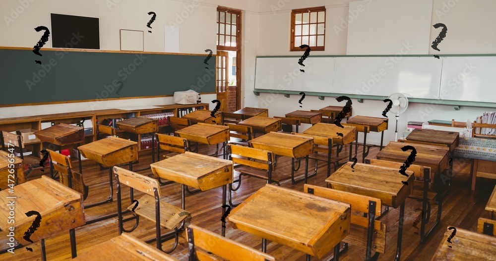 Wall mural Digital composite of black question marks over empty classroom with wooden desks in school