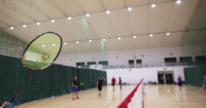 Badminton players on court for sport activity, indoor. On a badminton court where people practice badminton .Badminton and shuttlecocks.