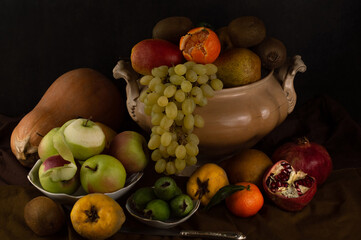 Still life in the Dutch style with fruits, vegetables and utensils.