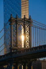 Travel to New York. The skyline of Manhattan photographed during a summer sunrise, view to Manhattan Bridge. Landmarks of United States of America. Skyscraper office buildings.