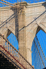 Fototapeta premium Travel to New York. The skyline of Manhattan photographed during a summer sunrise, view to Brooklyn Bridge. Landmarks of United States of America. Skyscraper office buildings.