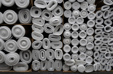 a roll of special insulation material is folded on a rack