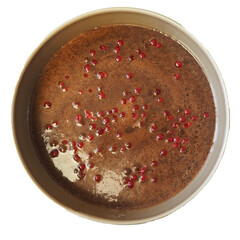 raw vegan brownie with red currants in a metal round shape. in front of the oven. top view. gluten- and lactose-free pastries