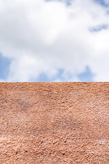 polyurethane foam wall texture with blur blue open sky background.