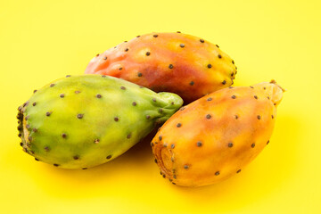 close up of Opuntia ficus indica, exotic fruits on yellow background