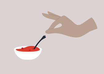 Hand reaching to a bowl of raspberry jam, breakfast traditional food