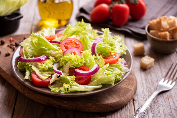 Green vegetable salad with lattuce, tomatos, onion. Healthy food concept