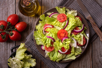 Green vegetable salad with lattuce, tomatos, onion. Healthy food concept