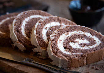 Delicious chocolate roll cake with white cream, homemade baked dessert