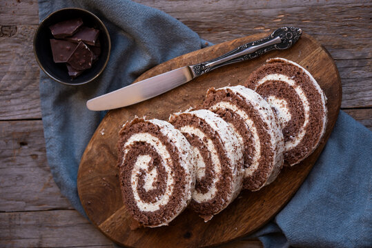Delicious chocolate roll cake with white cream, homemade baked dessert