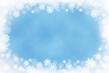 Winter wonderland snow scene with copy space. Winter background with a snowflake border and white vignetting.