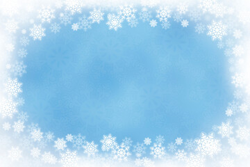Winter wonderland snow scene with copy space. Winter background with a snowflake border and white vignetting.
