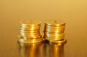 Metal coins on a gold background. The financial symbol.