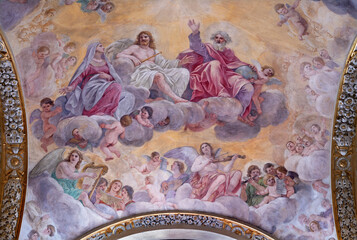 ROME, ITALY - AUGUST 29, 2021: The fresco of Holy Trinity with the Virgin Mary and angels in the church Basilica di san Crisogono by Giacinto Gimignany (1611 - 1681).