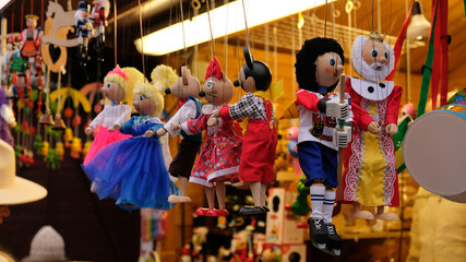 Traditional wooden puppet toys hang at a market stalls in Prague, Czech Republic. Marionette Puppet...