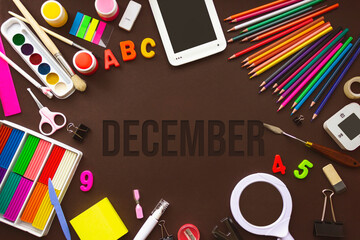December. Month, Calendar month. School notebook and various stationery with calendar day. School and office supplies frame. Winter , month of the year concept.