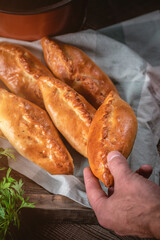 Fresh fried meat pies on rustic background