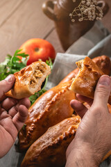 Fresh fried meat pies on rustic background