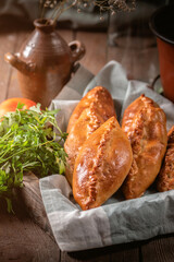 Fresh fried meat pies on rustic background