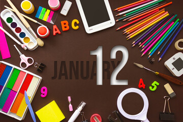 January 12nd. Day 12 of month, Calendar date. School notebook and various stationery with calendar day. School and office supplies frame. Winter month, day of the year concept.