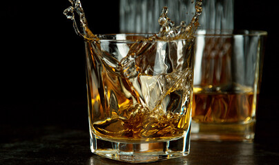 Freeze motion of falling ice cube into whisky