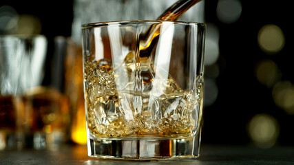 Freeze motion of pouring whisky into glass