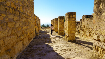 Fototapeta na wymiar Woman walking through the archaeological ruins of the ancient Arab city of Medina Azahara, Cordoba.