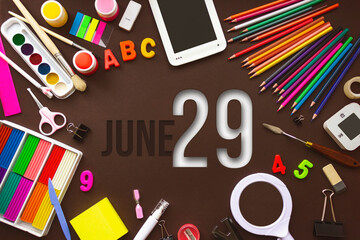 June 29th. Day 29 of month, Calendar date. School notebook and various stationery with calendar day. School and office supplies frame. Summer month, day of the year concept.