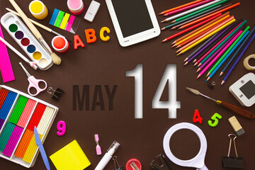 May 14th. Day 14 of month, Calendar date. School notebook and various stationery with calendar day. School and office supplies frame. Spring month, day of the year concept.