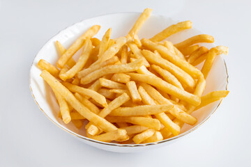 Crispy fries in a plate on white background. Hot american fast food.