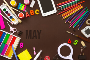 May. Month, Calendar month. School notebook and various stationery with calendar day. School and office supplies frame. Spring , month of the year concept.