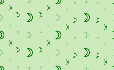 Seamless pattern of large and small green moon astrological symbols. The elements are arranged in a wavy. Vector illustration on light green background