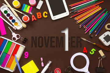 November 1st . Day 1 of month, Calendar date. School notebook and various stationery with calendar day. School and office supplies frame. Autumn month, day of the year concept.