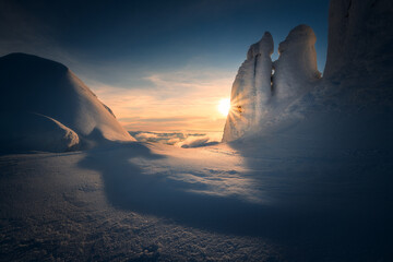 Fototapeta premium Amazing sunset scene in the mountains with some soft warm light hitting the peaks. The peaks resemble a kissing couple. Sunrise scene. Beautiful winter panorama