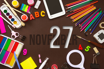 November 27th. Day 27 of month, Calendar date. School notebook and various stationery with calendar day. School and office supplies frame. Autumn month, day of the year concept.