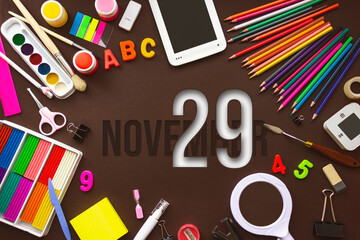 November 29th. Day 29 of month, Calendar date. School notebook and various stationery with calendar day. School and office supplies frame. Autumn month, day of the year concept.