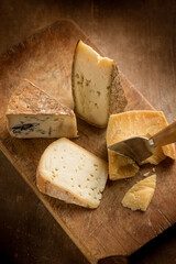 variety of traditional italian cheese over cutting board