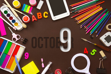 October 9th. Day 9 of month, Calendar date. School notebook and various stationery with calendar day. School and office supplies frame. Autumn month, day of the year concept.