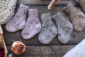 Fototapeta na wymiar Warm and soft tiny newborn socks made of woolen yarn