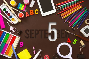 September 5th. Day 5 of month, Calendar date. School notebook and various stationery with calendar day. School and office supplies frame. Autumn month, day of the year concept.